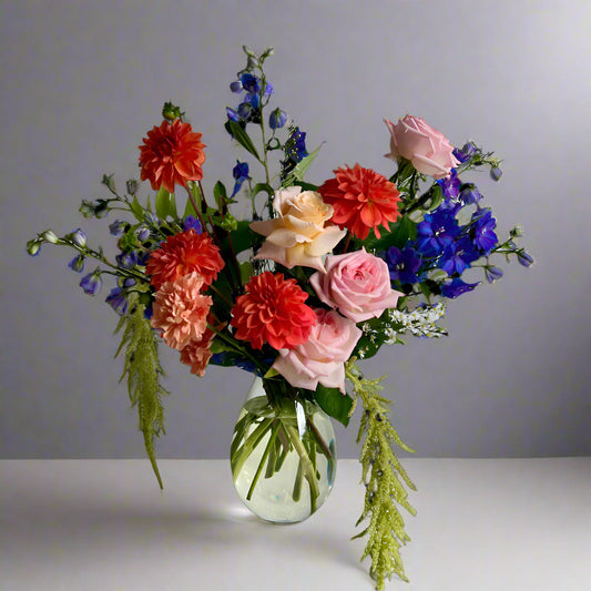 Brightly coloured flowers created into a glass vase.