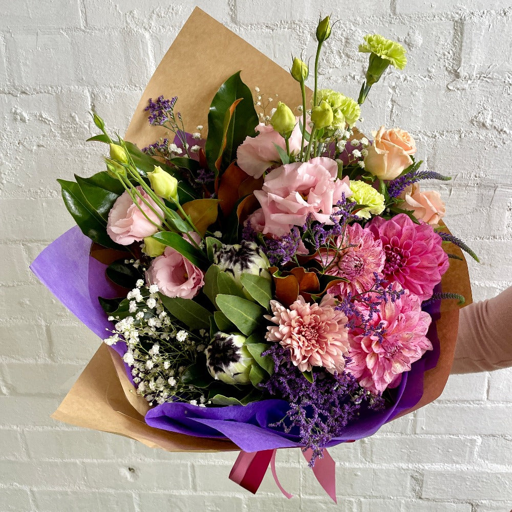 mixed bouquet with peach dahlias, white carnations, and pink lisianthusa