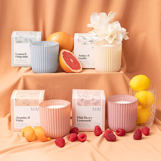 a selection of scented candles with fruits