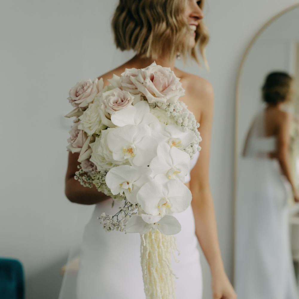 Elegant wedding bouquet with white roses and orchids