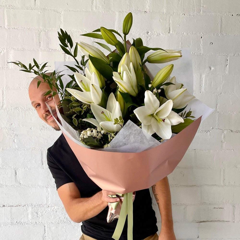 florist holding White Lilly Bouquet