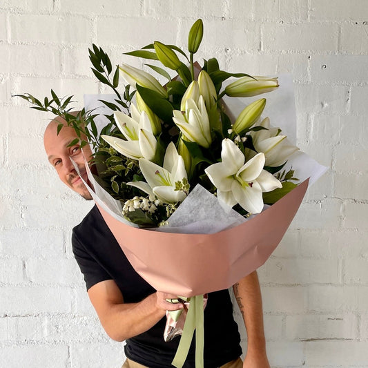 florist holding White Lilly Bouquet