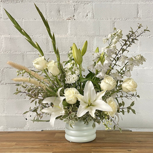Condolence vase arrangement featuring white lilies and roses 