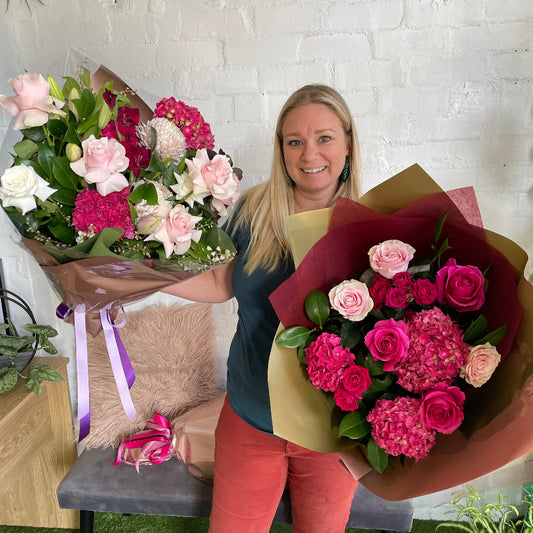 florist holding pink rose bouquet