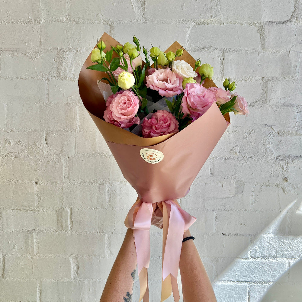 florist holding a bunch o Lisianthus