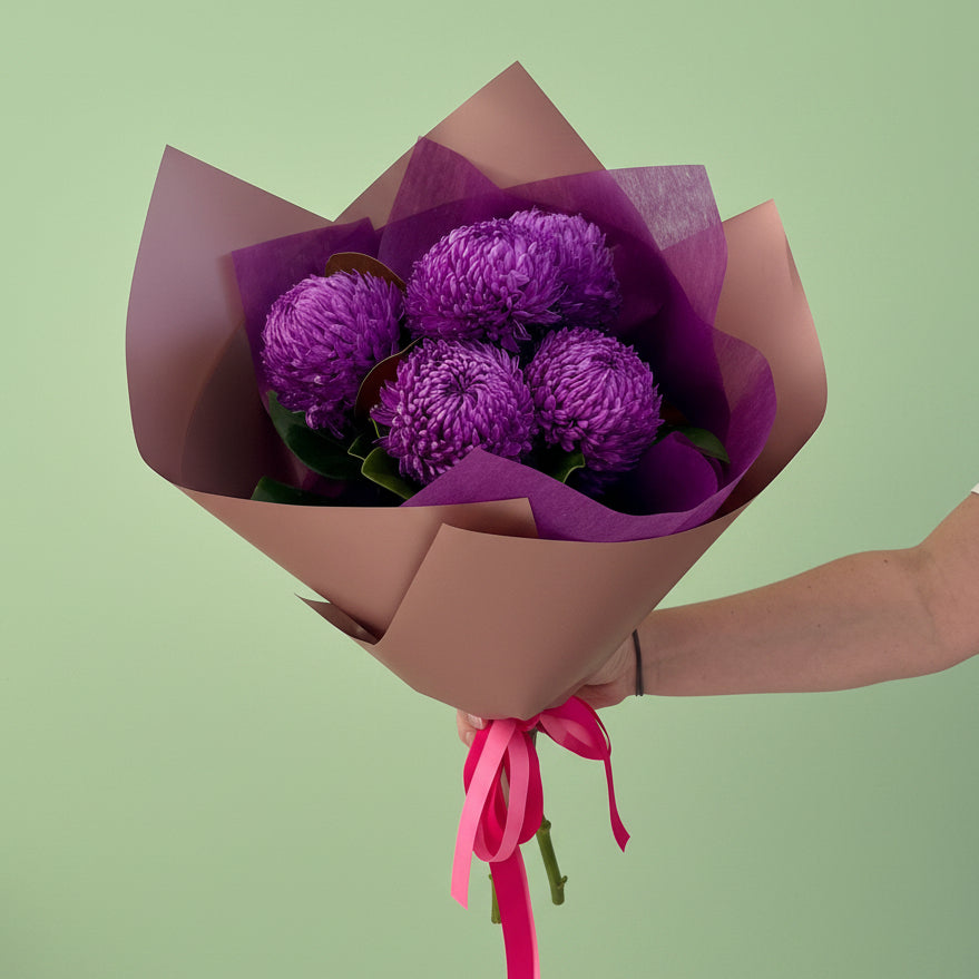 Purple disbud chrysanthemums in premium rose gold wrapping  with a pink ribbon