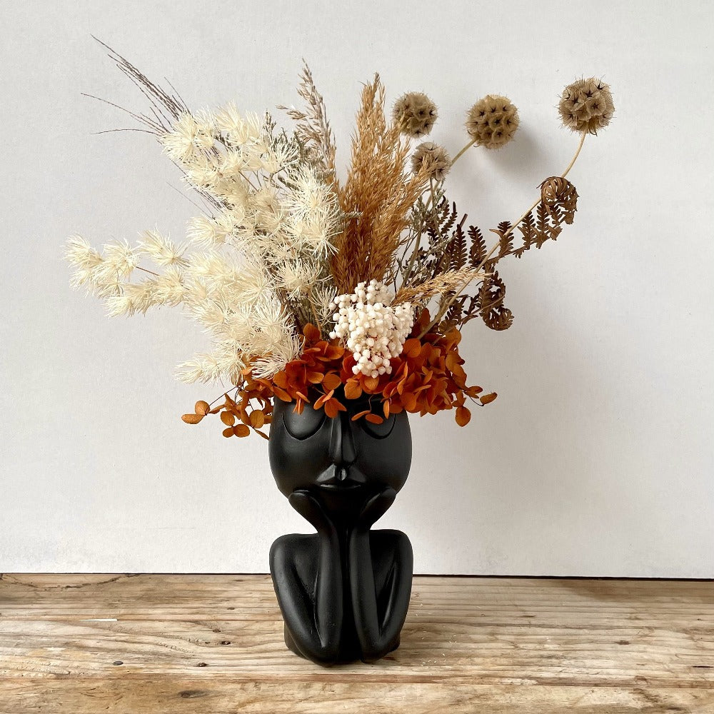 Black lady vase with preserved flowers