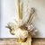 gold and white preserved flower arrangement