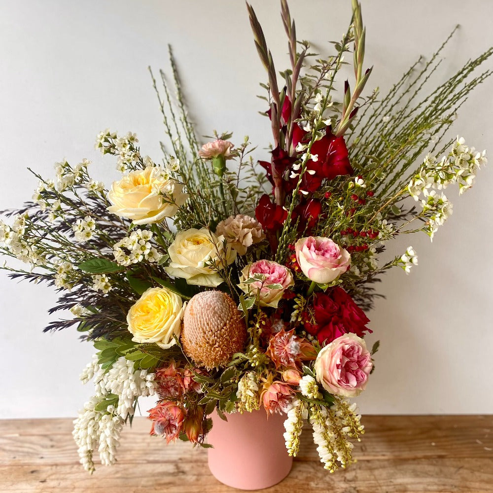 wild flower vase arrangement in pink ceramic vase