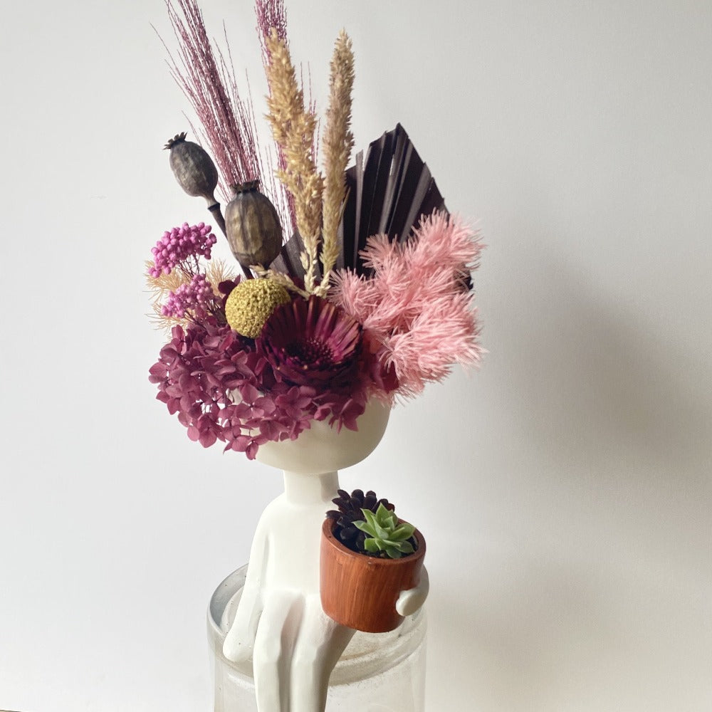 little man vase holding plant - preserved flower arranagement