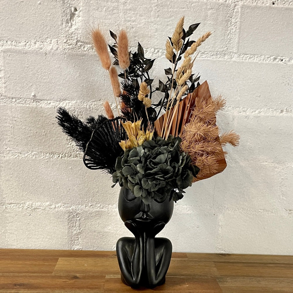 Black vase preserved flowers
